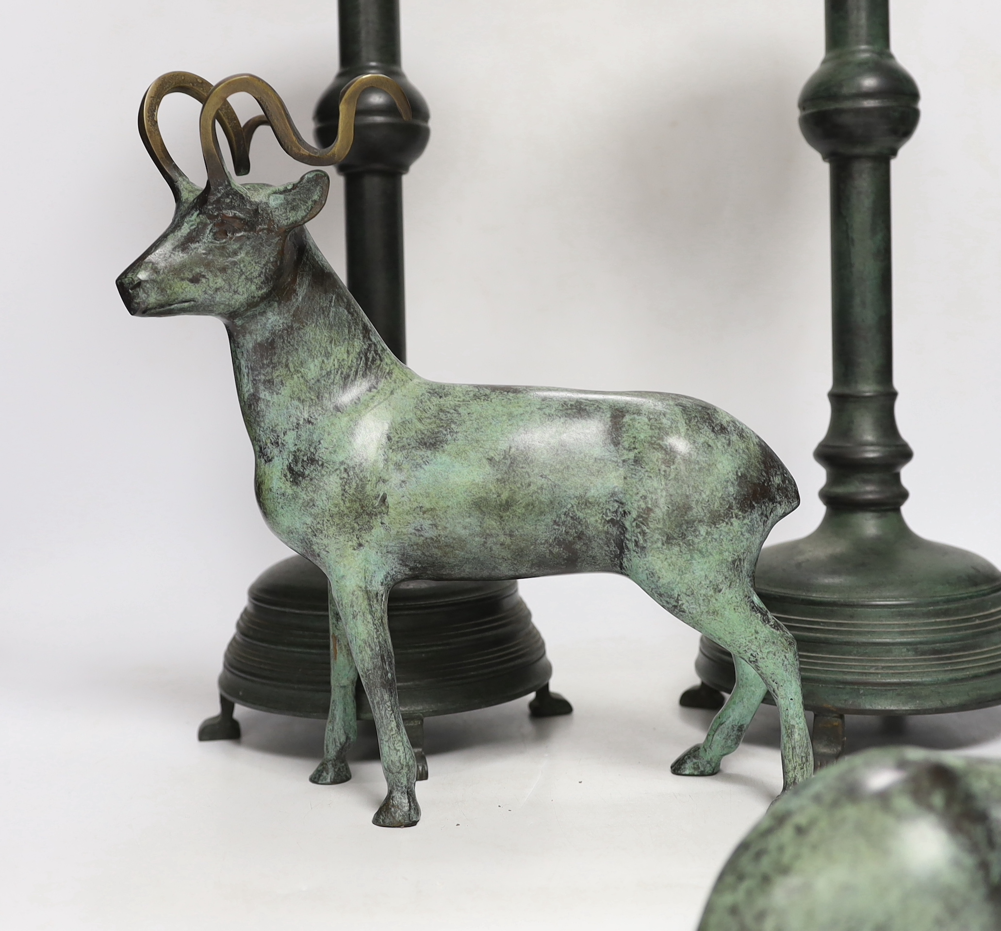 A pair of bronze candlesticks, 45.5cm, and a pair of stags, all with green patina